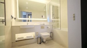 Slider shot of Modern Tiled Bathroom with Shower in modern home, real estate interior. Wide shot.