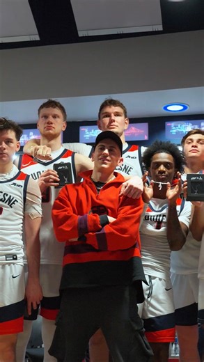 Duquesne Basketball on Instagram: "christmas drip surprise from santa 🎅⛓️ #GoDukes | @ohthatsdave | @shopgld ——————————————————— Audio/Video Description: Dave Dixon surprising teammates in locker room with chains with their number on it. Light music in background"