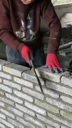 laying bricks with mortar to build a sturdy wall for a professional home construction and renovation