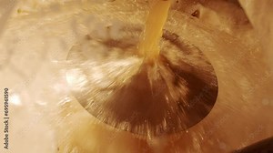 Preparation beer at brewery factory. Closeup on pouring produced beer in stainless steel tank. Process of making alcohol craft beverage, lager or ale. Professional equipment on plant
