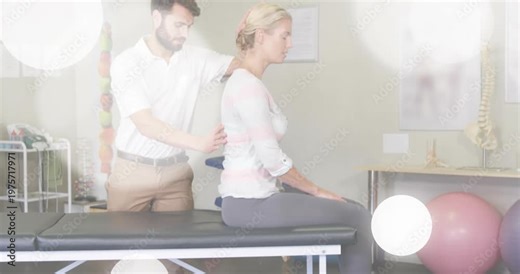Therapist placing hands on patient, starting spinal neck exam on table, bokeh overlay clearing