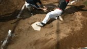 Overhead view of baseball player sliding into home plate