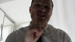 Angry worker in an office uniform with a tie. Scandal in the office. The director yells at the staff. Aggressive man, gesturing with his hand.