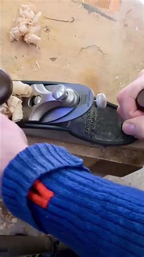 smoothing long wooden block surface using a sharp manual hand plane