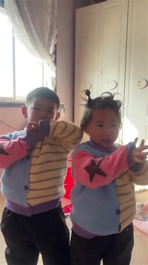 Adorable Kid Exchanges Red Envelopes with Cousin