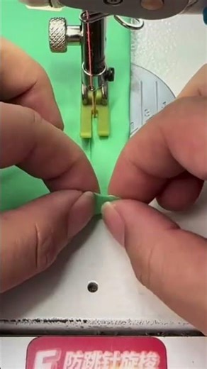 Sewing a green fabric precisely using a professional electric sewing machine tool for a neat finish