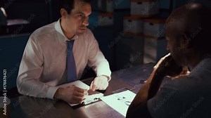 Police detective in interview room talking to a suspect or witness