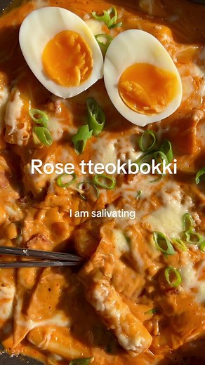 Rose tteokbokki (because I cant handle the spice of regular tteokbokki) 350g Korean rice cakes, soaked for about half an hour 4 flat Korean fish cakes (or more if you like it like I do) 100g or so bacon or Korean sausage Half an onion, sliced 1 spring onion, plus extra to garnish 2 cloves garlic, minced 1 tbsp vegetable oil, as needed depending on the fattiness of your bacon/sausages 200 mL milk, plus extra as needed 200 mL pouring cream 1 tsp gochugaru (korean chilli flakes) 1.5 tbsp soy 1 tbsp