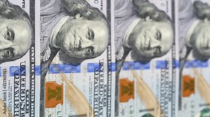US 100 dollar bills close up tracking. One hundred dollars background. Slider shot, low angle. 4K
