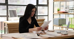 Stressed frustrated business woman reading bad news in paper letter. Manager feels frustrated by denial of debt notice or financial report