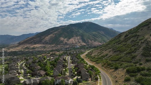 Draper, Utah in the Wasatch Front Mountains with a view of the LDS Temple on a summer day - forward aerial hyper lapse