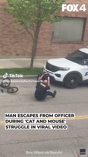 A video of a bizarre scuffle between a police officer and a man on the street has gone viral, racking up more than 10 million views on Instagram. Broc Wilson, a local resident in Cincinnati, Ohio, captured the exchange on video, describing it as a “cat and mouse” chase. The footage shows an officer getting shoved to the ground while trying to restrain a man, who then attempts to flee by bicycle but falls to the ground himself. A slow-paced chase ensues involving the officer trying to pepper spra