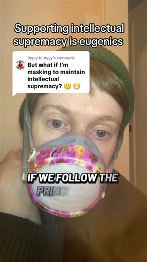 Replying to @Ayyy #ableism #intelectualsupremacy #disabilityjustice #disabled #wearamask statement reads: “What if I mask to support intellectual supremacy” Supporting intellectual supremacy is eugenics. Image description: middle aged whyte person wearing a white, grey and pink respirator with green hat and short orange hair and green fleece