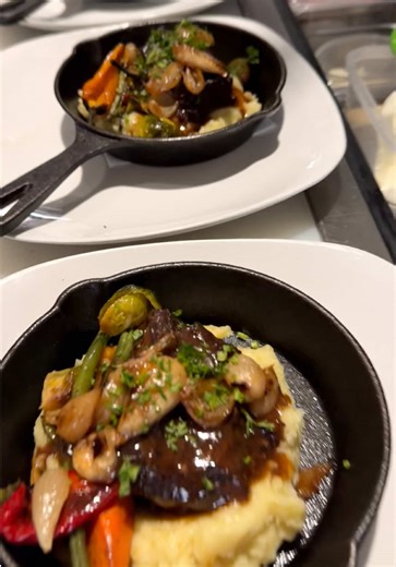 Heat. Patience. Precision. At the Dennis Di Chef Showcase, comfort food leveled up. Slow-braised beef, glazed in a rich, glossy reduction, resting over buttery mashed potatoes like it earned that spot. Roasted carrots, green beans, blistered peppers, pearl onions, and mushrooms layered in for texture and depth. Finished with fresh herbs because balance is everything. This is the kind of dish that respects time. Low and slow. Built on technique. Finished with intention. Rustic presentation in a c