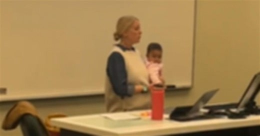 Professor holds college student's baby during class