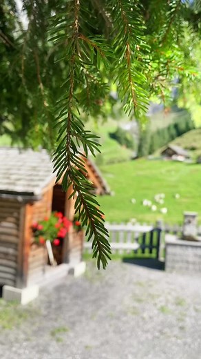 Serene Countryside Scene with Waterfall and Cabins