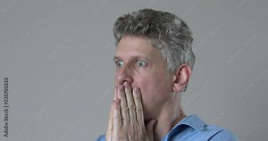 Man closeup face being frightened, surprised and showing concern
