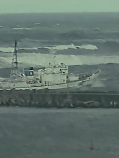 Fishing Boat Navigates Rough Seas Amid Tsunami Warnings