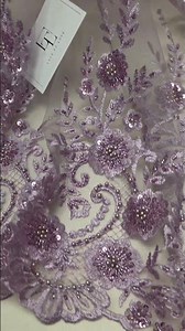 Purple beaded lace fabric