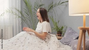 Shocked scared young adult woman waking up after bed scary dream screaming with frighten face being astonished yelling with negative motions bad morning Stock Video