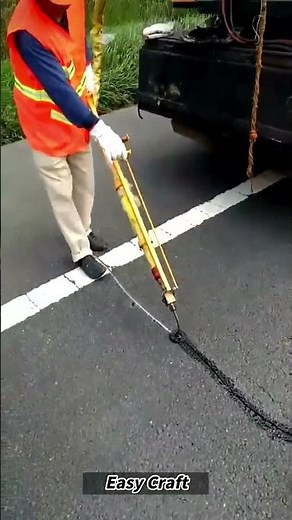 Filling Asphalt Cracks with Hot Tar