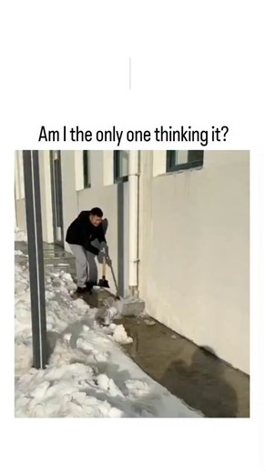buzz__decode on Instagram: "The post features a 41-second video of an East Asian man using a pickaxe to chip away a massive icicle buildup from a building's exterior drainpipe during a snowy day, with water cascading down as the ice breaks apart. The caption "Am I the only one thinking it?" prompts humorous interpretations of the phallic-shaped ice formation, sparking innuendo-filled replies like "frozen water stick" jokes amid widespread confusion. Posted on January 5, 2026, by @DefiantLs , a h