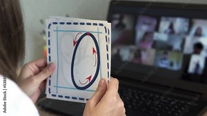 An elementary school teacher conducts an online lesson for children. Distance lesson, learning at home, technologies for a schoolchild, business conference. Children do their homework at home.