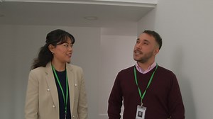 Free stock video - Male and female teachers wearing security lanyards talking as they walk along corridor in school building together 1