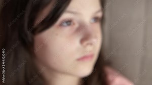 Delighted girl with freckles on cheeks. A joyful child show her freckles on her face indoor.