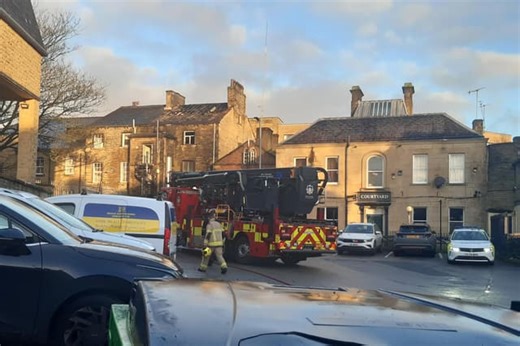 Police tape off Halifax town centre takeaway building after blaze burns through roof