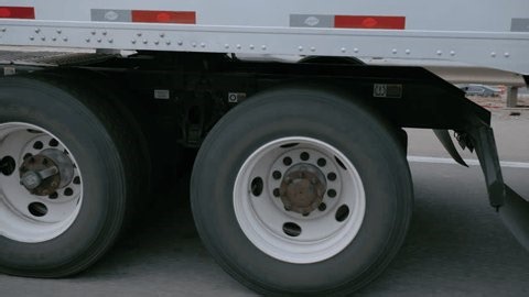 clip-3966115985-pov-close-semi-truck-wheels-axle-fuel-tank