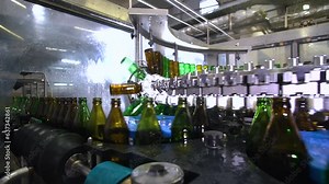 Conveyor with glass bottles at the plant for the production of various beers, soda, water or other alcoholic or soft drinks.