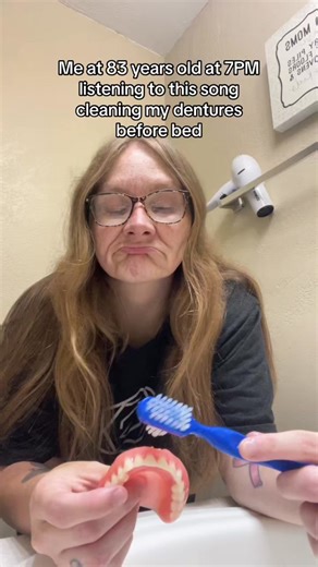 Elderly Woman Cleaning Dentures at 83 Years Old