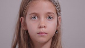 Closeup portrait of serious girl looking at camera