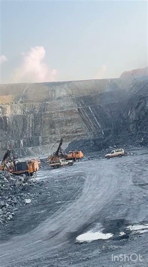 Day to day operations of a grade control rig and drill and blast rig at a production mine site