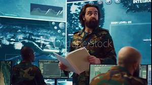 Army major reads operation details from a case file in a control center military headquarters, manages personnel and resources for logistical or operational missions. Task force command. Camera A.