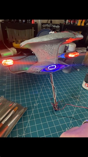 Never a full day on the model workbench! Working toward the finish of the #AMT Enterprise-D. Everything was going well until I had a failure in my main power cable running to the base (😖). There was no way to get to the broken connection. Magically, there was still continuity from the connector to the saucer section so I had a life line to pivot with! I ran a cable down the front of the neck, around the deflector housing, and to the support rod. This was, then, puttied over to hide it. Not perf