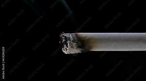 Zooming in Shot of the Tip of a Cigarette Slowly Consuming itself, Emitting a Trail of Smoke, in Front of a Black Background