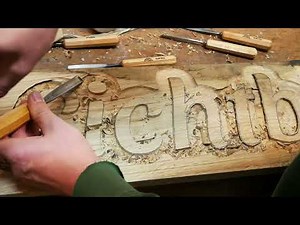 A plaque with raised lettering made of oak is created.