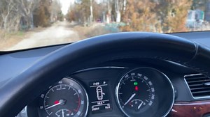 Hearse funeral vehicle slowly driving along the alley of cemetery among the tombstones. Hearse driver point of view. Orthodox cemetery