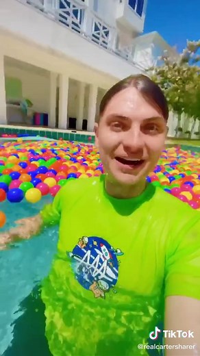 Swimming in a pool filled will ball pit balls at the Team RAR house
