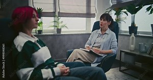 Female psychotherapist provides psychological support in office during therapy session. Teen patient talks about problems, discusses family issues. Psychological assistance. Mental health concept.