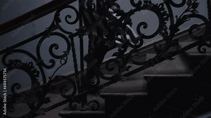 a girl in black and white dress running up the stairs of an old house. middle shot. She is wearing knee-high leggings,recorded in slow motion, daytime, outdoor