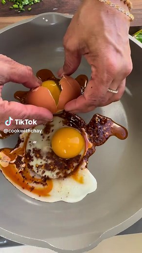 Chili oil eggs 1. tablespoons chili oil/crisp 2. 2-3 eggs 3. Pinch of salt 4. Chopped chives or green onions 5. Sourdough toast toasted with olive oil 6. Sriracha Mayo 7. On a medium hot (not high heat or the chili oil will burn) drizzle chili oil in the center. 8. Drop your eggs right over the chili oil. 9. Keep the heat on medium and let the eggs cook for about two minutes until the eggs have set or your desired consistency 10. leave open faced or flip into an omelette. 11. Make sure to keep t