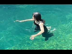 wetlook a pretty woman swims in lake