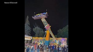 Carnival ride sways back and forth with people aboard