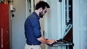 Specialist configuring server rack in server room