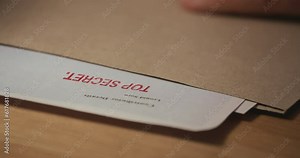 Taked confidential document with seal Top Secret, close-up shot