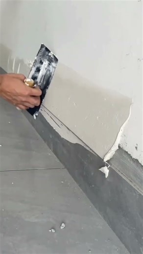 Filling wall crack using putty knife during surface repair #construction #popular