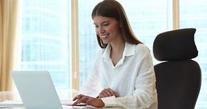 Woman sit at workplace desk typing on laptop keyboard work in modern office, student make notes in copybook, jotting thoughts, creative ideas studying at home looks focused. Planning, business